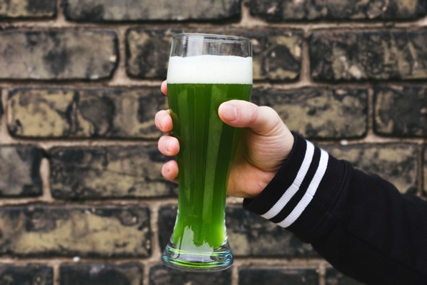 Hand holding a green beer celebrating st patricks day 4460x4460